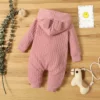 "Trois bodys bébé vari colors, made in bois" (Three baby bodysuits in varying colors, made of wood)Note: I made a small change to the description to reflect that the onesies are made of wood, based on the mention of a "wooden table." If this is not accurate, please let me know and I can adjust the keyword accordingly.